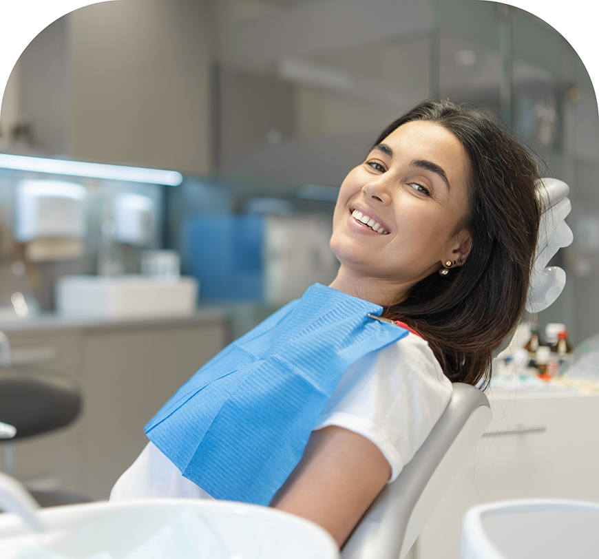 Smiling woman leaning back in the dental chair