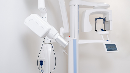 CT cone beam scanning machine standing against a wall