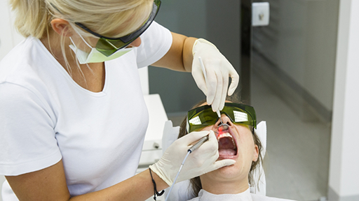 Dental patient having their gums treated with a laser
