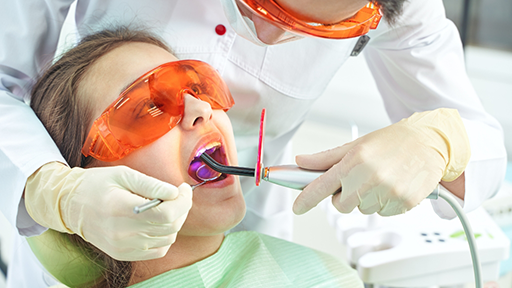 Woman receiving cosmetic dental bonding on her teeth