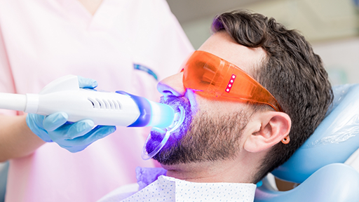 Dental patient getting his teeth whitened