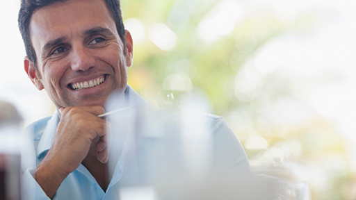 Man smiling in a pale blue button-down shirt