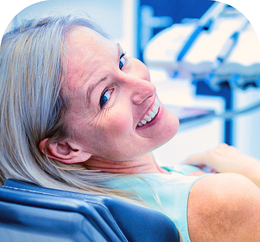 Woman in the dental chair smiling over her shoulder