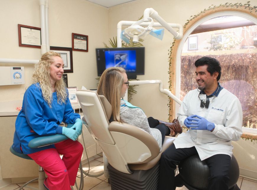 Dentist near Studio City talking to a patient in the treatment chair