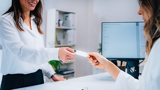 Woman paying for her dental treatment