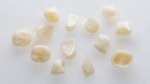 Several dental crowns against a white background