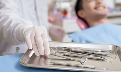 Dentist preparing to treat a patient