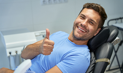 Man giving a thumbs up in the dental chair