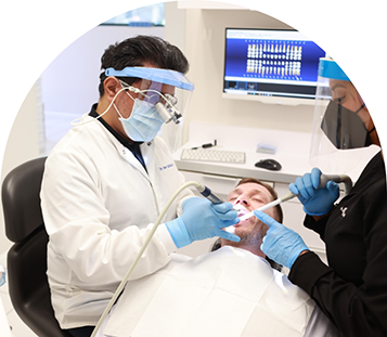 Doctor Ruiz and a dental assistant treating a patient