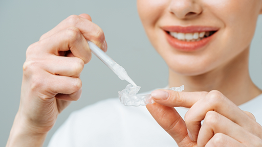 Person using a teeth whitening kit