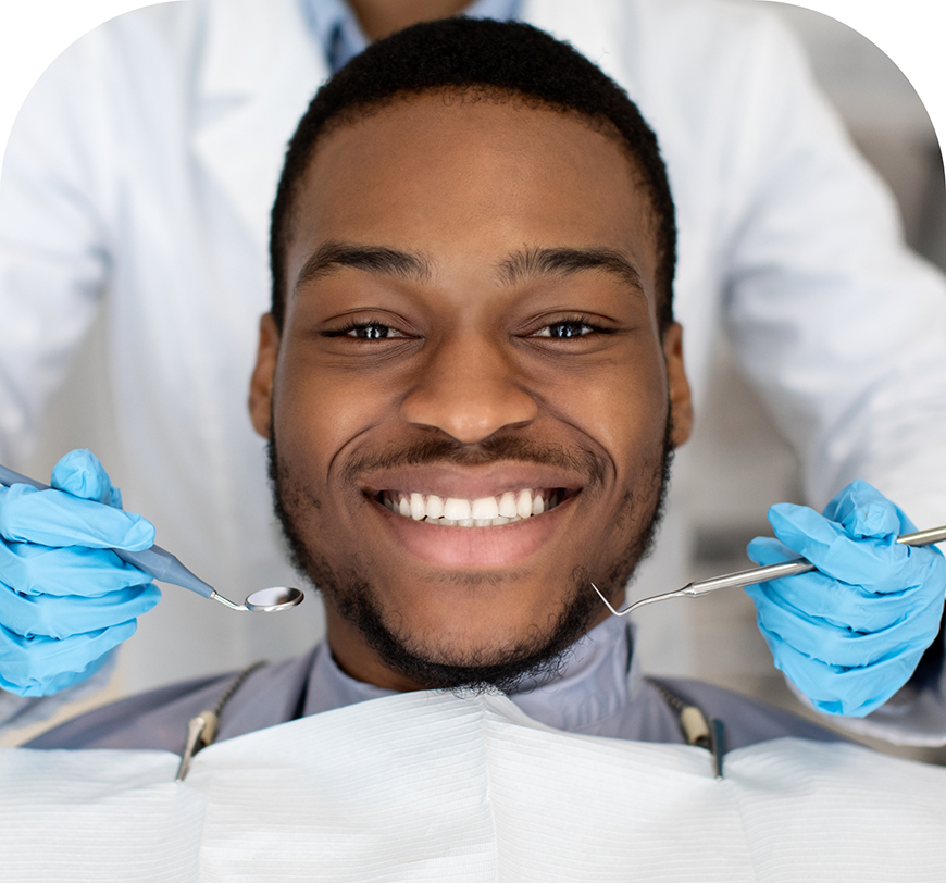 Man grinning in the dental chair with tooth-colored fillings in Burbank