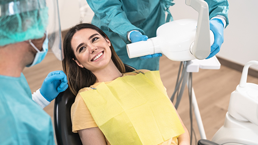 Woman grinning at her dentist during a checkup
