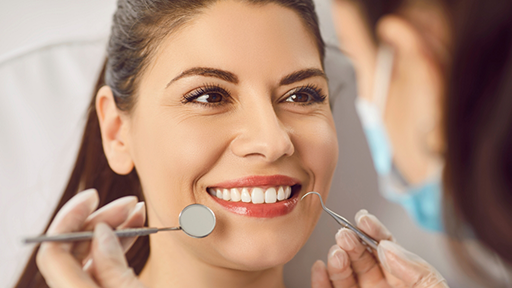 Brunette woman smiling at her dentist