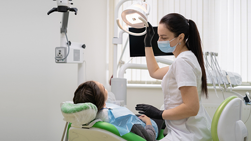 Dental hygienist preparing to give a patient a teeth cleaning