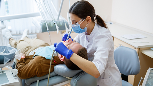 Emergency dentist treating a patient