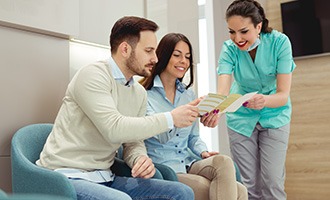 A couple consulting their dentist about dental insurance