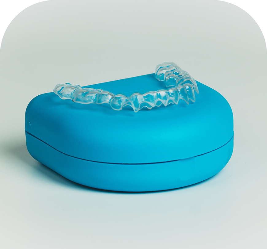 Invisalign clear aligner on top of its plastic case