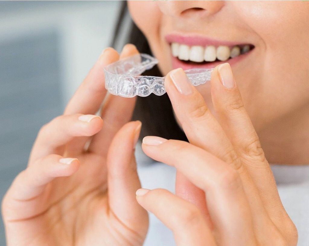 woman holding Invisalign